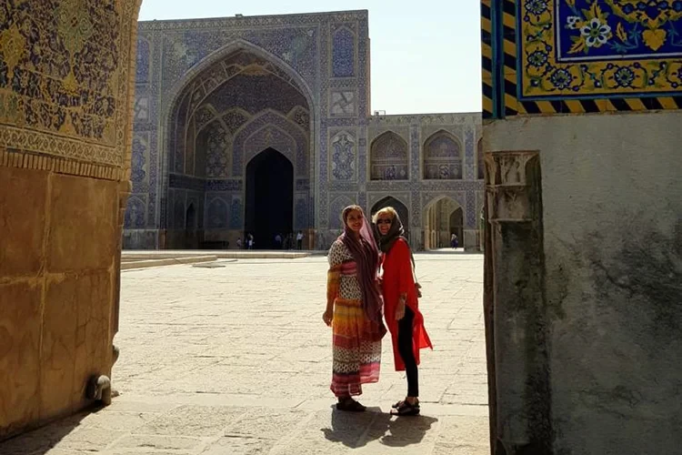 An escorted Isfahan tour of Uppersia with a tour guide in Shah mosque in Isfahan